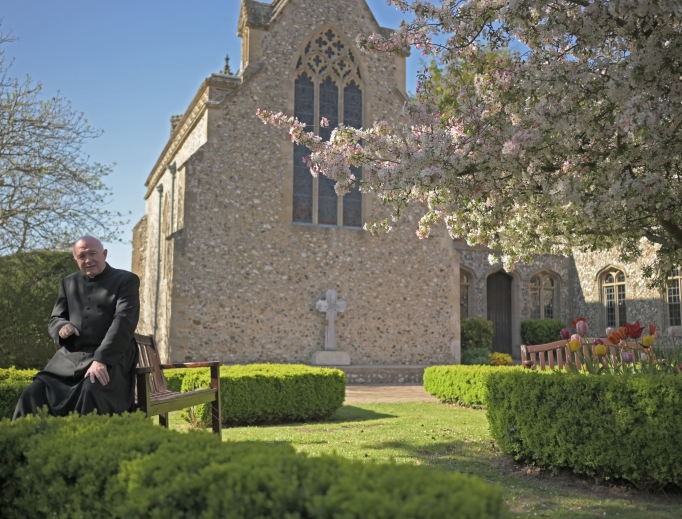 Msgr. John Armitage, shown enjoying the garden and praying at the Walsingham shrine, says, ‘Our Lady wanted us to make the dedication in the midst of this storm.’ Msgr. John Armitage, shown enjoying the garden and praying at the Walsingham shrine, says, ‘Our Lady wanted us to make the dedication in the midst of this storm.’
