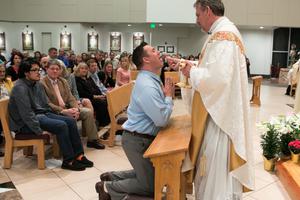 Tanner Rogers receives first Holy Communion at the Easter vigil 2019. Tanner Rogers receives first Holy Communion at the Easter vigil 2019.