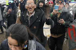 In this 2017, file photo,Nathan Phillips (center with glasses), marches out of the Oceti Sakowin camp before the deadline set for evacuation of the camp near Cannon Ball, North Dakota. Phillips was part of a large crowd representing a majority of the remaining Dakota Access Pipeline protesters, A source close to the leadership of the National Basilica of the Shrine of the Immaculate Conception in Washington corroborated an eyewitness account that saw Phillips and a group of activists tried to enter the church during Mass while playing drums and chanting. They were prohibited from entering the building by security personnel, who locked the main basilica doors with the congregation still inside. In this 2017, file photo,Nathan Phillips (center with glasses), marches out of the Oceti Sakowin camp before the deadline set for evacuation of the camp near Cannon Ball, North Dakota. Phillips was part of a large crowd representing a majority of the remaining Dakota Access Pipeline protesters, A source close to the leadership of the National Basilica of the Shrine of the Immaculate Conception in Washington corroborated an eyewitness account that saw Phillips and a group of activists tried to enter the church during Mass while playing drums and chanting. They were prohibited from entering the building by security personnel, who locked the main basilica doors with the congregation still inside.