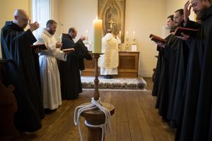 Above and below, the monks pray at Mass and have fellowship at their priory. Also below, on Feb. 25, Bishop Michael Smith of Meath presided at the canonical establishment of their new monastery at Silverstream. 