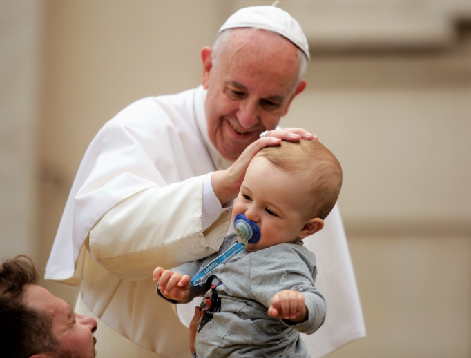 Pope Francis greets a baby before leading the Regina Caeli in St. Peter’s Square April 30, 2017. Pope Francis greets a baby before leading the Regina Caeli in St. Peter’s Square April 30, 2017.