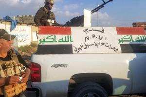 Above, the NPU, a Christian militia, escorts the Syriac Catholic archbishop of Mosul on a trip into the city. Above, the NPU, a Christian militia, escorts the Syriac Catholic archbishop of Mosul on a trip into the city.