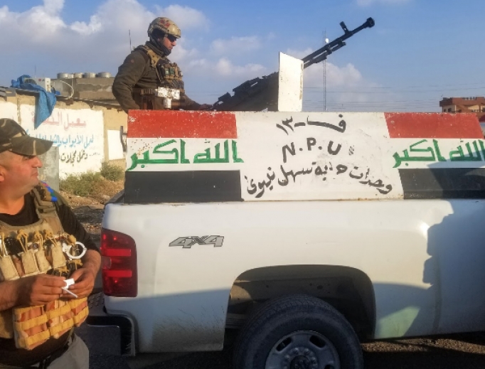 Above, the NPU, a Christian militia, escorts the Syriac Catholic archbishop of Mosul on a trip into the city. Above, the NPU, a Christian militia, escorts the Syriac Catholic archbishop of Mosul on a trip into the city.