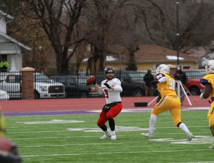 Quarterback Shaefer Schuetz, No. 9, shown at work on the field, has a pregame routine that includes adoration time. Other Ravens are also shown on the gridiron, including No. 19, Logan Harris. Quarterback Shaefer Schuetz, No. 9, shown at work on the field, has a pregame routine that includes adoration time. Other Ravens are also shown on the gridiron, including No. 19, Logan Harris.