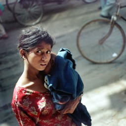 An Indian woman carries her infant child along a busy street in New Delhi, in 2005. An Indian woman carries her infant child along a busy street in New Delhi, in 2005.