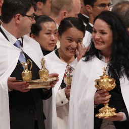 A new member of the Church shows her emotions as she and five others baptized and confirmed by Pope Benedict XVI carry the offertory gifts during the Easter Vigil Mass the Pope celebrated in St. Peter's Basilica in 2010. A new member of the Church shows her emotions as she and five others baptized and confirmed by Pope Benedict XVI carry the offertory gifts during the Easter Vigil Mass the Pope celebrated in St. Peter's Basilica in 2010.