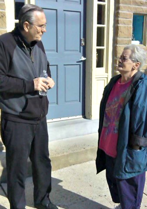 Father Doug McKay talks with a Grays Ferry resident in front of the Matt Talbot House. Below, a Mass is held at Our House Ministries in Philadelphia. Father Doug McKay talks with a Grays Ferry resident in front of the Matt Talbot House. Below, a Mass is held at Our House Ministries in Philadelphia.