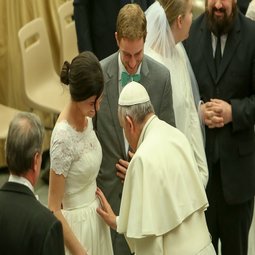 Pope Francis blesses a baby in the womb and the parents, a newly married couple, on Feb. 4. Pope Francis blesses a baby in the womb and the parents, a newly married couple, on Feb. 4.