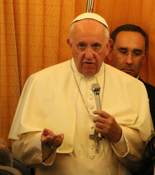 Pope Francis answers a reporter's question during his June 26 flight to Rome at the end of his three-day papal visit to Armenia. Pope Francis answers a reporter's question during his June 26 flight to Rome at the end of his three-day papal visit to Armenia.