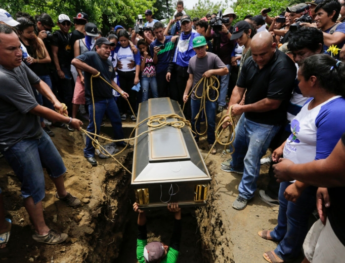 Friends and relatives bury the body of student Gerald Vasquez, who was shot dead during clashes with riot police in Divine Mercy Church in Managua, Nicaragua, July 16. Friends and relatives bury the body of student Gerald Vasquez, who was shot dead during clashes with riot police in Divine Mercy Church in Managua, Nicaragua, July 16.