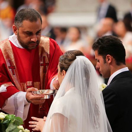 A couple newly married by Pope Francis receives Communion in St. Peter’s Basilica on Sept. 14, 2014.
A couple newly married by Pope Francis receives Communion in St. Peter’s Basilica on Sept. 14, 2014.