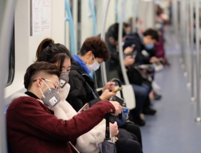People wearing surgical masks sitting on a subway in Shanghai, January 2020. People wearing surgical masks sitting on a subway in Shanghai, January 2020.