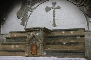 Signs of the unspeakable violence perpetrated on Iraqi Christians by the Islamic State: Above, bullet holes and a defaced cross mar the main altar of St. Addai’s Church in Karemlash. Below,
Chaldean Father Thabet Yousif pokes through the rubble that was once his family home; a torn red curtain marks what is left of the sanctuary of St. Mary the Virgin Church in Karemlash; the tomb of martyred priest Father Ragheed Ganni; and Ghazala, an Iraqi Christian who resisted Islamic State militants when they overthrew her town. Signs of the unspeakable violence perpetrated on Iraqi Christians by the Islamic State: Above, bullet holes and a defaced cross mar the main altar of St. Addai’s Church in Karemlash. Below,
Chaldean Father Thabet Yousif pokes through the rubble that was once his family home; a torn red curtain marks what is left of the sanctuary of St. Mary the Virgin Church in Karemlash; the tomb of martyred priest Father Ragheed Ganni; and Ghazala, an Iraqi Christian who resisted Islamic State militants when they overthrew her town.