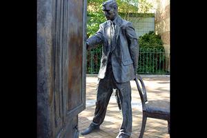 Entitled ‘The Searcher’, this Belfast statue of C.S. Lewis looking into a wardrobe was sculpted by Ross Wilson.
Entitled ‘The Searcher’, this Belfast statue of C.S. Lewis looking into a wardrobe was sculpted by Ross Wilson.