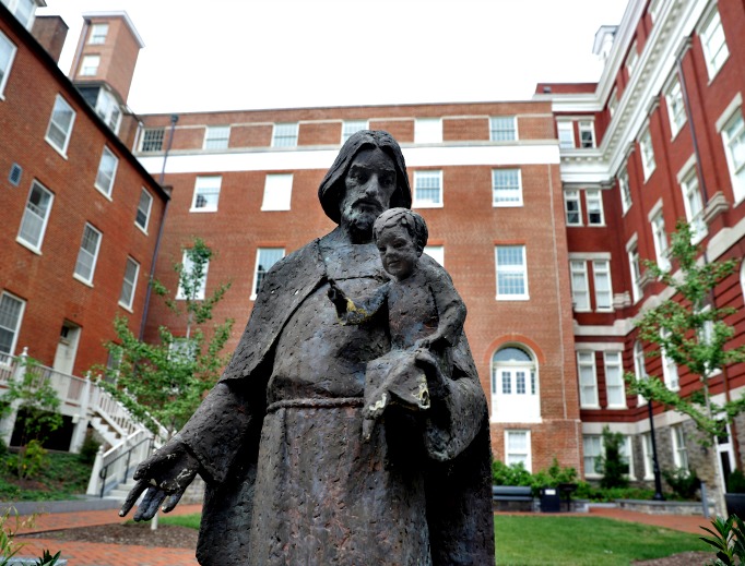 A Jesuit statue is seen in front of Freedom Hall, formerly named Mulledy Hall, on the Georgetown University campus on Sept. 1 in Washington. After renaming the Mulledy and McSherry buildings at Georgetown University temporarily Freedom Hall and Remembrance Hall, Georgetown University will give preference in admissions to the descendants of slaves owned by the Maryland Jesuits as part of its effort to atone for profiting from the sale of enslaved people. A Jesuit statue is seen in front of Freedom Hall, formerly named Mulledy Hall, on the Georgetown University campus on Sept. 1 in Washington. After renaming the Mulledy and McSherry buildings at Georgetown University temporarily Freedom Hall and Remembrance Hall, Georgetown University will give preference in admissions to the descendants of slaves owned by the Maryland Jesuits as part of its effort to atone for profiting from the sale of enslaved people.