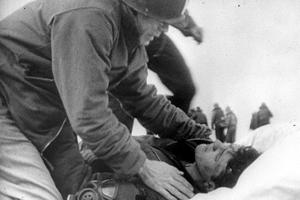 Father Joseph T. O'Callahan tends to an injured crewman aboard the USS Franklin (CV-13), after the ship was set afire by a Japanese air attack on March 19, 1945 — the Feast of St. Joseph. Father Joseph T. O'Callahan tends to an injured crewman aboard the USS Franklin (CV-13), after the ship was set afire by a Japanese air attack on March 19, 1945 — the Feast of St. Joseph.