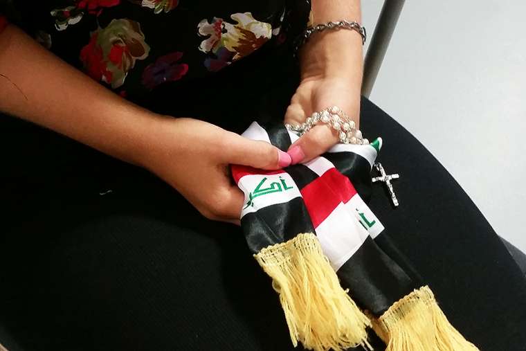 Iraqi woman holding a rosary. Iraqi woman holding a rosary.