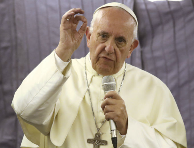 Pope Francis talks with journalists during his flight from Lima, Peru, to Rome Jan. 21. Pope Francis talks with journalists during his flight from Lima, Peru, to Rome Jan. 21.