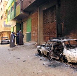 Several burned cars belonging to Egyptian Christians remain in the street after clashes April 6 between Muslims and Christians in a Cairo suburb. Several burned cars belonging to Egyptian Christians remain in the street after clashes April 6 between Muslims and Christians in a Cairo suburb.