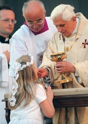 A girl kneels as she receives Communion from Pope Benedict XVI during Mass in May 2008. A girl kneels as she receives Communion from Pope Benedict XVI during Mass in May 2008.