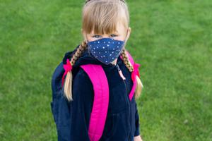A young girl is prepared for school amid the coronavirus pandemic. A young girl is prepared for school amid the coronavirus pandemic.