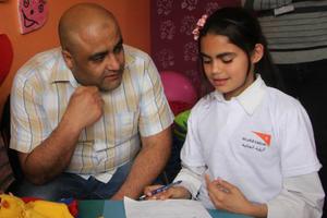 Mohammed Halabi, World Vision’s operations manager in Gaza, speaks with a child. Mohammed Halabi, World Vision’s operations manager in Gaza, speaks with a child.