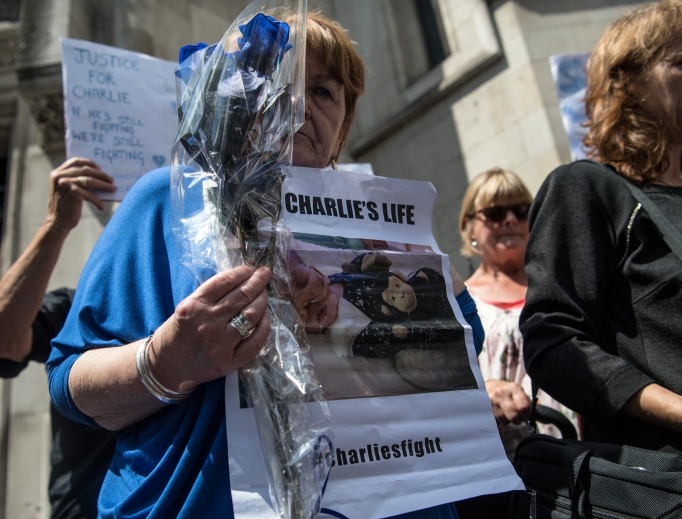 Supporters of Chris Gard and Connie Yates, the parents of terminally ill baby Charlie Gard, take part in a demonstration outside the U.K. High Court as Gard and Yates attend a case relating to their son on July 10. Supporters of Chris Gard and Connie Yates, the parents of terminally ill baby Charlie Gard, take part in a demonstration outside the U.K. High Court as Gard and Yates attend a case relating to their son on July 10.