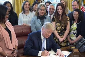 U.S. President Donald Trump signs H.R. 1865, the "Allow States and Victims to Fight Online Sex Trafficking Act of 2017" at the White House April 11. With Trump are victims and family members of victims of online sex trafficking and members of Congress who helped pass the bill. U.S. President Donald Trump signs H.R. 1865, the "Allow States and Victims to Fight Online Sex Trafficking Act of 2017" at the White House April 11. With Trump are victims and family members of victims of online sex trafficking and members of Congress who helped pass the bill.