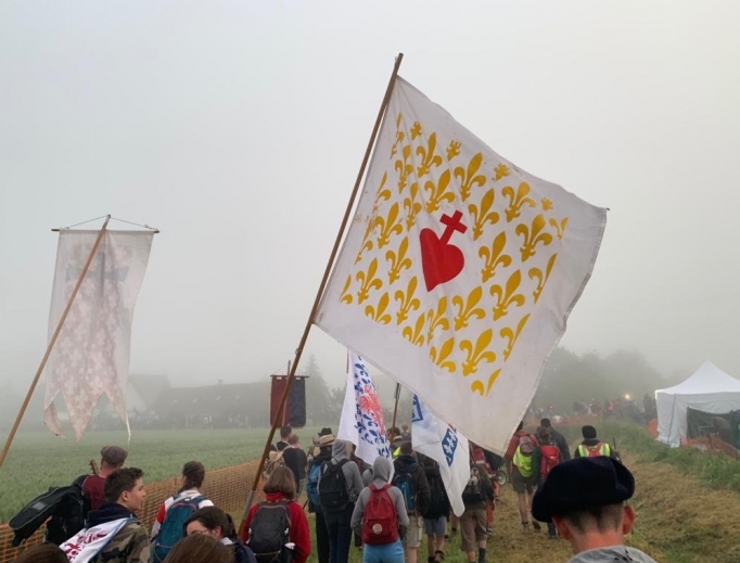 Above: Pilgrims pray along the way from Paris to Chartres, France.
Below: A French flag displaying the Most Sacred Heart of Jesus with 'Hope and Salvation of France' written in French. A priest hears confession while other pilgrims participate in adoration in the background (at the final campsite of the pilgrimage in Gas, France, about 12 miles from Chartres). The arrival and concluding Mass at the Cathedral of Notre Dame in Chartres. Also below: The banner from the American delegation of Our Lady of the Most Holy Rosary displayed at the meeting at L'église Saint-Sulpice de Paris. The pilgrimage group Our Lady of the Most Holy Rosary was from Minnesota. Above: Pilgrims pray along the way from Paris to Chartres, France.
Below: A French flag displaying the Most Sacred Heart of Jesus with 'Hope and Salvation of France' written in French. A priest hears confession while other pilgrims participate in adoration in the background (at the final campsite of the pilgrimage in Gas, France, about 12 miles from Chartres). The arrival and concluding Mass at the Cathedral of Notre Dame in Chartres. Also below: The banner from the American delegation of Our Lady of the Most Holy Rosary displayed at the meeting at L'église Saint-Sulpice de Paris. The pilgrimage group Our Lady of the Most Holy Rosary was from Minnesota.