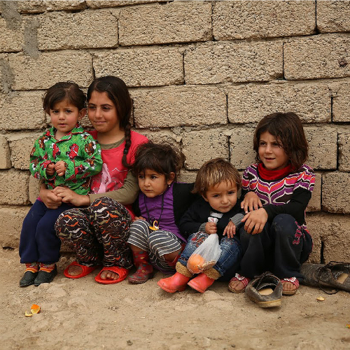 Refugee children huddle against a wall at the Sharia Al Haman Hope Refugee Camp in Duhok, Iraq, on March 28, 2015. Refugee children huddle against a wall at the Sharia Al Haman Hope Refugee Camp in Duhok, Iraq, on March 28, 2015.