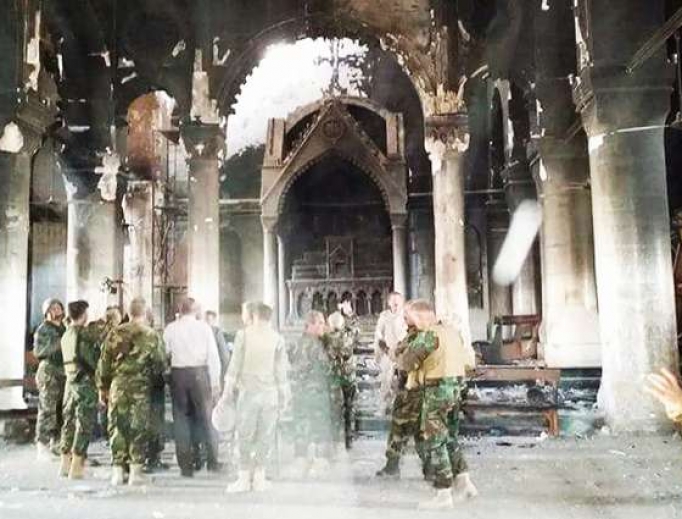 Pershmerga fighters inspect Al Tamera Syriac Catholic parish in Qaraqosh, Iraq, after the city’s recent liberation from the Islamic State. Pershmerga fighters inspect Al Tamera Syriac Catholic parish in Qaraqosh, Iraq, after the city’s recent liberation from the Islamic State.