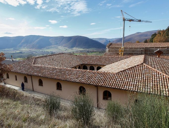 The temporary monastery, shown above and below, is a refuge for the monks, who live according to the way of life exhibited by their patron, St. Benedict. Their monastery was damaged by an earthquake in 2016 and is undergoing extensive repairs (also shown). The temporary monastery, shown above and below, is a refuge for the monks, who live according to the way of life exhibited by their patron, St. Benedict. Their monastery was damaged by an earthquake in 2016 and is undergoing extensive repairs (also shown).