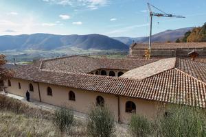 The temporary monastery, shown above and below, is a refuge for the monks, who live according to the way of life exhibited by their patron, St. Benedict. Their monastery was damaged by an earthquake in 2016 and is undergoing extensive repairs (also shown). The temporary monastery, shown above and below, is a refuge for the monks, who live according to the way of life exhibited by their patron, St. Benedict. Their monastery was damaged by an earthquake in 2016 and is undergoing extensive repairs (also shown).
