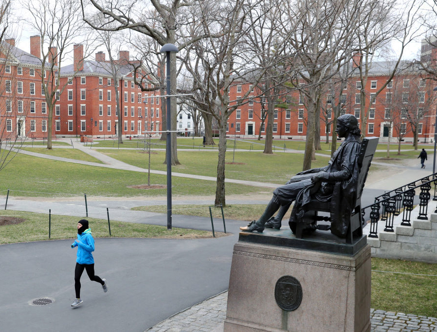 A runner crosses Harvard Yard on March 23, 2020 in Cambridge, Massachusetts. A runner crosses Harvard Yard on March 23, 2020 in Cambridge, Massachusetts.