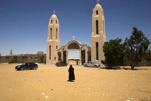 A priest walks in front of St. Samuel the Confessor Monastery, about 140 miles south of Cairo, Egypt, May 27. Masked gunmen ambushed a bus carrying Coptic Christians on their way to the monastery on Friday, killing 29 people. A priest walks in front of St. Samuel the Confessor Monastery, about 140 miles south of Cairo, Egypt, May 27. Masked gunmen ambushed a bus carrying Coptic Christians on their way to the monastery on Friday, killing 29 people.