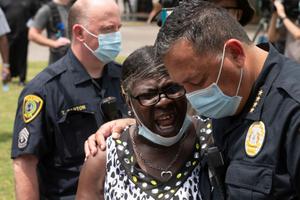 Houston Police Chief Art Acevedo prays with a woman while people wait in line to attend the public viewing for George Floyd at the Fountain of Praise church in Houston on June 8. Houston Police Chief Art Acevedo prays with a woman while people wait in line to attend the public viewing for George Floyd at the Fountain of Praise church in Houston on June 8.