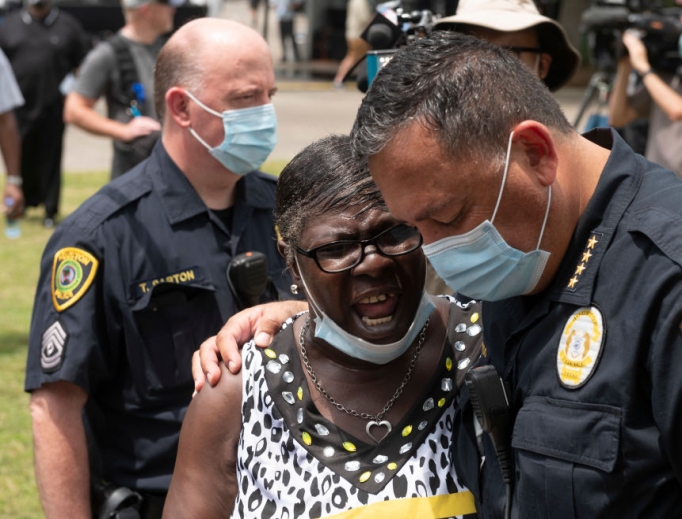 Houston Police Chief Art Acevedo prays with a woman while people wait in line to attend the public viewing for George Floyd at the Fountain of Praise church in Houston on June 8. Houston Police Chief Art Acevedo prays with a woman while people wait in line to attend the public viewing for George Floyd at the Fountain of Praise church in Houston on June 8.