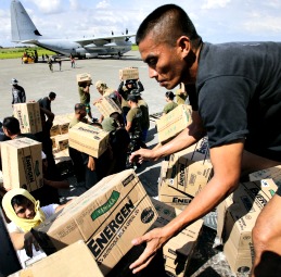 Philippine Army personnel unload relief goods to be transported to regions affected by Typhoon Bopha, from the Marine Corps KC-130J Hercules aircraft inside the International Airport in Davao, Mindanao Dec. 15. Philippine Army personnel unload relief goods to be transported to regions affected by Typhoon Bopha, from the Marine Corps KC-130J Hercules aircraft inside the International Airport in Davao, Mindanao Dec. 15.
