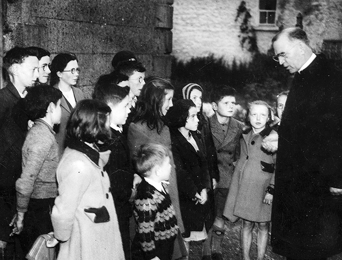 Father Flanagan talking with children in his hometown of Ballymoe, Ireland, in 1946.
Father Flanagan talking with children in his hometown of Ballymoe, Ireland, in 1946.