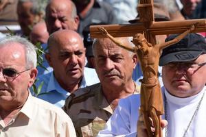 A religious procession takes place in Qaraqosh, Iraq. Father Andrzej Halemba, shown at front right holding the crucifix, is the Middle East head of Aid to the Church in Need; the aid organization says the situation is dire for Iraqi Christians. A religious procession takes place in Qaraqosh, Iraq. Father Andrzej Halemba, shown at front right holding the crucifix, is the Middle East head of Aid to the Church in Need; the aid organization says the situation is dire for Iraqi Christians.