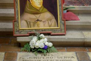 The grave of St. Junípero Serra, ‘Apostle of California,’ is located near the altar of the Carmel Mission in Carmel-by-the-Sea, California. The grave of St. Junípero Serra, ‘Apostle of California,’ is located near the altar of the Carmel Mission in Carmel-by-the-Sea, California.