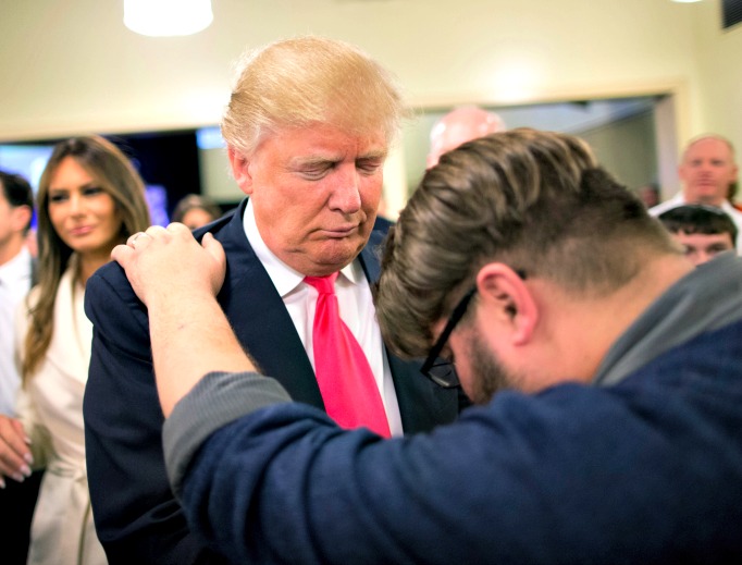 Pastor Joshua Nink prays with Republican presidential candidate Donald Trump, who was raised Presbyterian, after a service at First Christian Church on Jan. 31 in Council Bluffs, Iowa. Below, Hillary Clinton attend a service at the First United Methodist Church in Huntington, W. Va. Pastor Joshua Nink prays with Republican presidential candidate Donald Trump, who was raised Presbyterian, after a service at First Christian Church on Jan. 31 in Council Bluffs, Iowa. Below, Hillary Clinton attend a service at the First United Methodist Church in Huntington, W. Va.