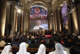 The image of Pope Benedict XVI reading the Bible on a live television feed is projected inside the Basilica of the Holy Cross in Rome. The image of Pope Benedict XVI reading the Bible on a live television feed is projected inside the Basilica of the Holy Cross in Rome.