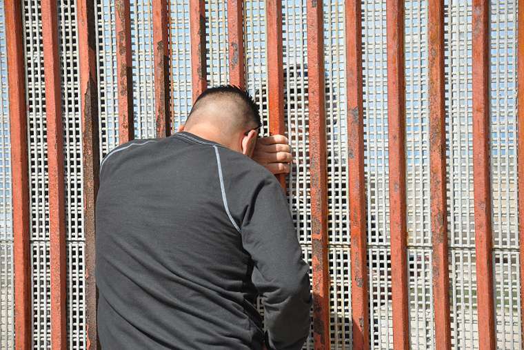 Families meet through a border fence Families meet through a border fence