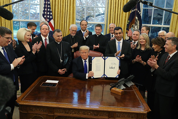 U.S. President Donald Trump signs H.R. 390, the 'Iraq and Syria Genocide Relief and Accountability Act of 2018' in the Oval Office at the White House Dec. 11 in Washington, D.C. Those supporting aid efforts in the region, including Archbishop Bashar Warda of the Chaldean Catholic Diocese of Erbil, Carl Anderson of the Knights of Columbus and New Jersey Rep. Chris Smith, were in attendance. U.S. President Donald Trump signs H.R. 390, the 'Iraq and Syria Genocide Relief and Accountability Act of 2018' in the Oval Office at the White House Dec. 11 in Washington, D.C. Those supporting aid efforts in the region, including Archbishop Bashar Warda of the Chaldean Catholic Diocese of Erbil, Carl Anderson of the Knights of Columbus and New Jersey Rep. Chris Smith, were in attendance.
