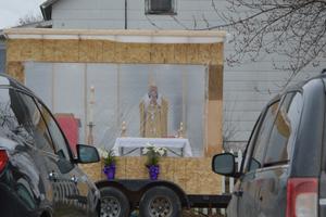 Father Michael Klos celebrates a drive-in Mass on Easter Sunday 2020 in the Sacred Heart Church parking lot in Cashton, Wisconsin. Father Michael Klos celebrates a drive-in Mass on Easter Sunday 2020 in the Sacred Heart Church parking lot in Cashton, Wisconsin.