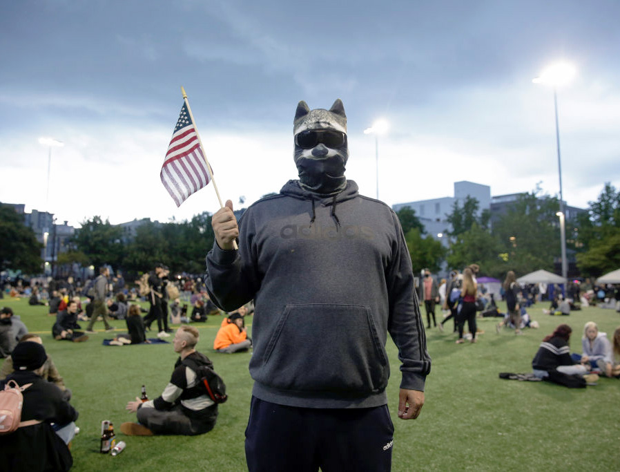A man who wished to remain anonymous is pictured wearing a raccoon mask in an area being called the Capitol Hill Autonomous Zone (CHAZ) located around streets reopened to pedestrians after the Seattle Police Department's East Precinct was vacated in Seattle, Washington on June 12, 2020. A man who wished to remain anonymous is pictured wearing a raccoon mask in an area being called the Capitol Hill Autonomous Zone (CHAZ) located around streets reopened to pedestrians after the Seattle Police Department's East Precinct was vacated in Seattle, Washington on June 12, 2020.