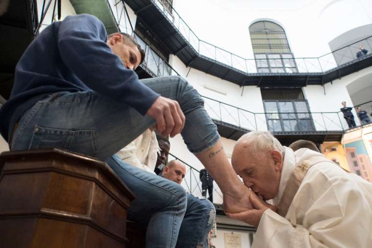 Pope Francis kisses a prisoner’s foot at Rome’s Regina Coeli Prison March 29. Pope Francis kisses a prisoner’s foot at Rome’s Regina Coeli Prison March 29.