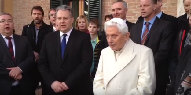 Pope Emeritus Benedict XVI and Bavarian dignitaries singing a German Christmas carol outside his residence on Friday. Pope Emeritus Benedict XVI and Bavarian dignitaries singing a German Christmas carol outside his residence on Friday.