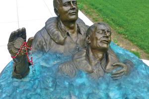 Above, a statue in Waterbury, Connecticut, depicts Father Thomas Conway in the ocean aiding a drowning sailor after the USS Indianapolis was torpedoed in 1945. Also below: Father Thomas Conway celebrates Mass aboard ship. A prayer card, shown below, offers devotion for the beloved chaplain’s eternal rest. The chaplain was awarded various medals, also shown, for his valor. Above, a statue in Waterbury, Connecticut, depicts Father Thomas Conway in the ocean aiding a drowning sailor after the USS Indianapolis was torpedoed in 1945. Also below: Father Thomas Conway celebrates Mass aboard ship. A prayer card, shown below, offers devotion for the beloved chaplain’s eternal rest. The chaplain was awarded various medals, also shown, for his valor.